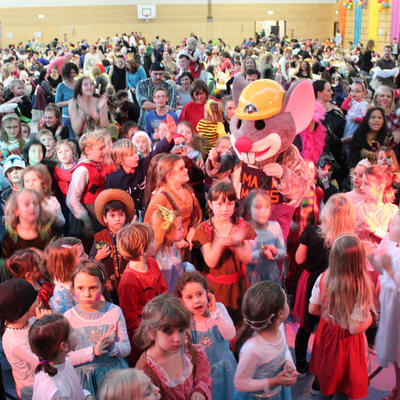 Bild vergr��ern: Das Bild zeigt die MAXI-Maus mit den Kindern beim Bonbon-Tanz.